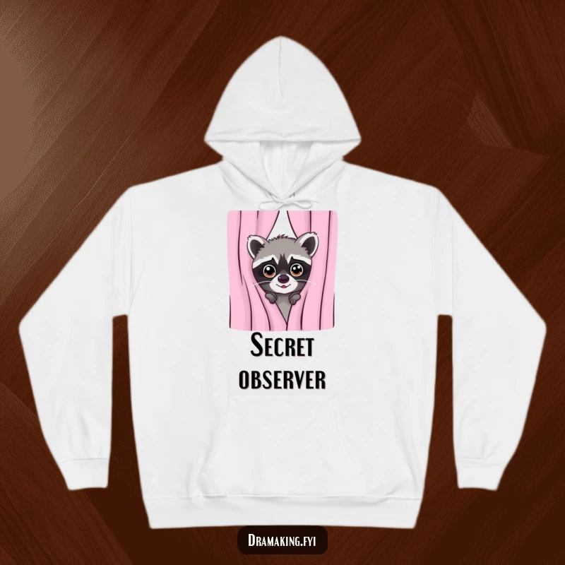 Funny hoodie print of a mischievous raccoon peeking from behind a curtain with wide, alert eyes, suggesting a playful hidden presence.