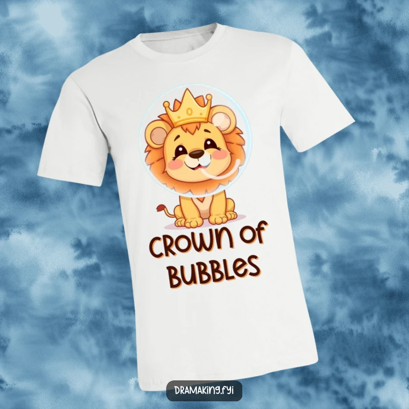 Funny lion cub t-shirt showing a cheerful character blowing a large soap bubble with a tiny crown reflection, perfect for kids.